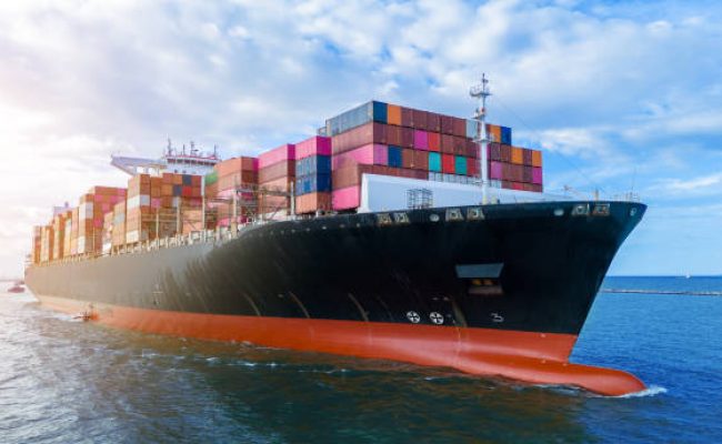 Aerial side view of cargo ship carrying container and running for export cargo yard port to custom ocean concept technology transportation , customs clearance, webinar banner forwarder mast